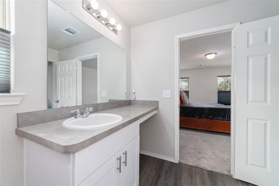 Both bathrooms showcase modern finishes and contemporary design, with sleek fixtures, ample counter space, and tiled flooring for a fresh and functional space. The master bath includes a spacious vanity and stylish accents.