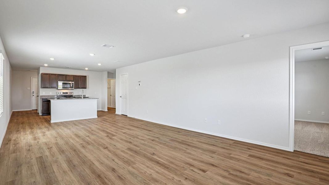 An open floorplan seamlessly connects the well-appointed kitchen to the living area, offering ideal flow for daily living.