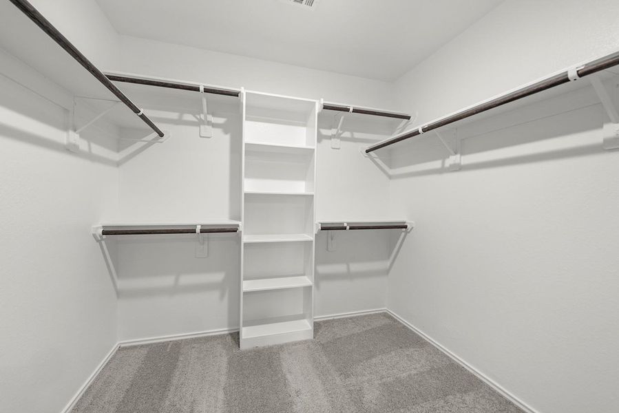 A stylish walk-in closet awaits, providing ample storage for your wardrobe and a little extra room for those cherished items. A stylish walk-in closet awaits, providing ample storage for your wardrobe and a little extra room for those cherished items.