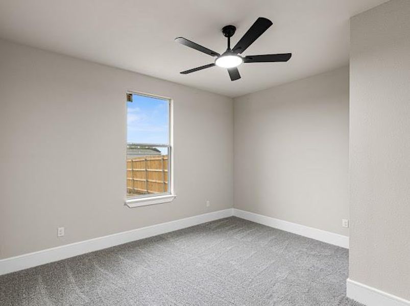 Empty room featuring light colored carpet and a ceiling fan Empty room featuring light colored carpet and a ceiling fan
