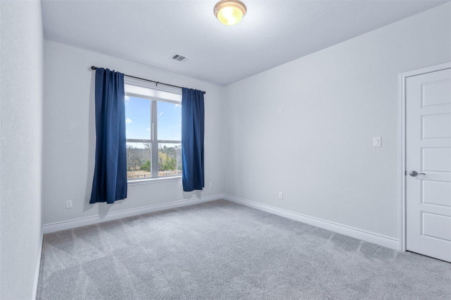 Spare room with light colored carpet