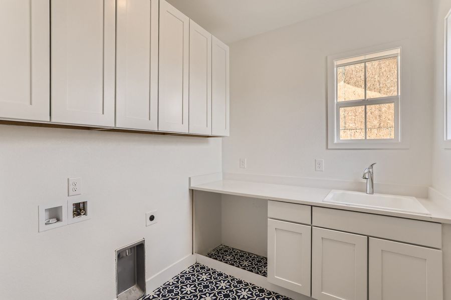 Upstairs laundry room in Cornell II plan at The Outlook at Southshore by Century Communities