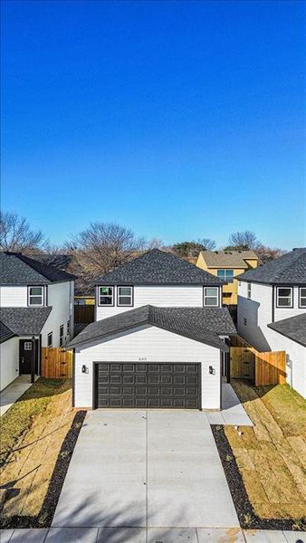 View of front of house with a garage and a front lawn