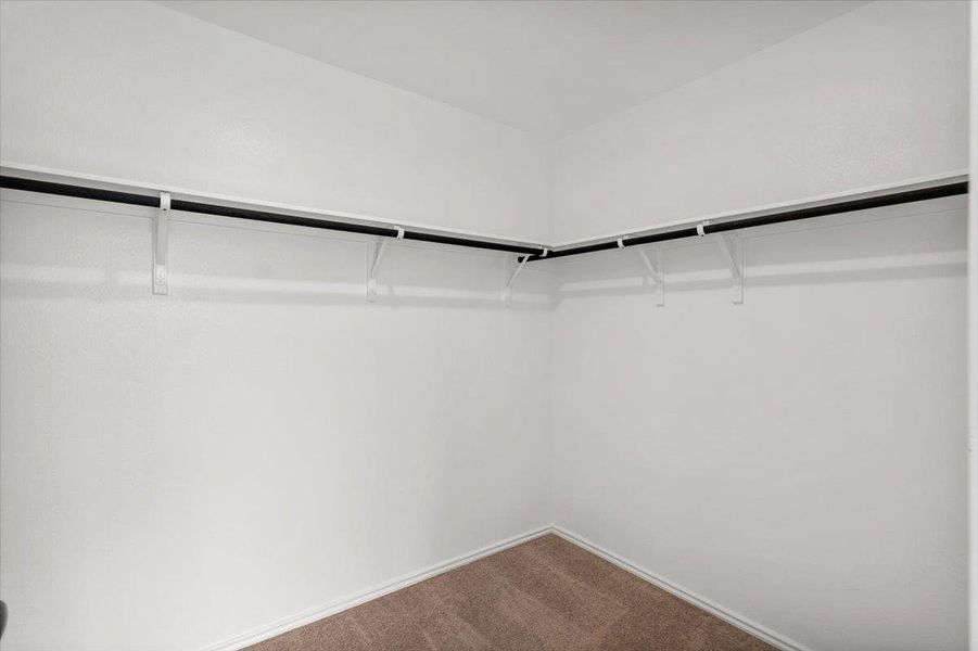 A well-organized closet offers ample storage with sturdy shelving and hanging rods. A well-organized closet offers ample storage with sturdy shelving and hanging rods.