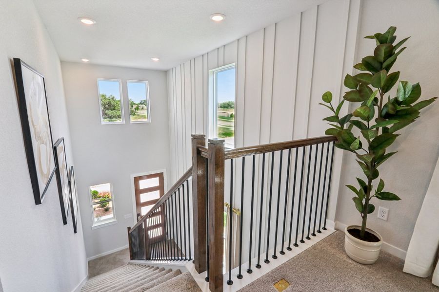 A room with a plant and a railing.