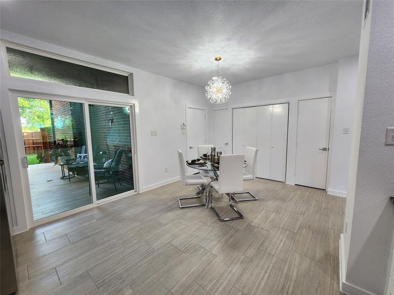 Dining room featuring an inviting chandelier and a textured ceiling