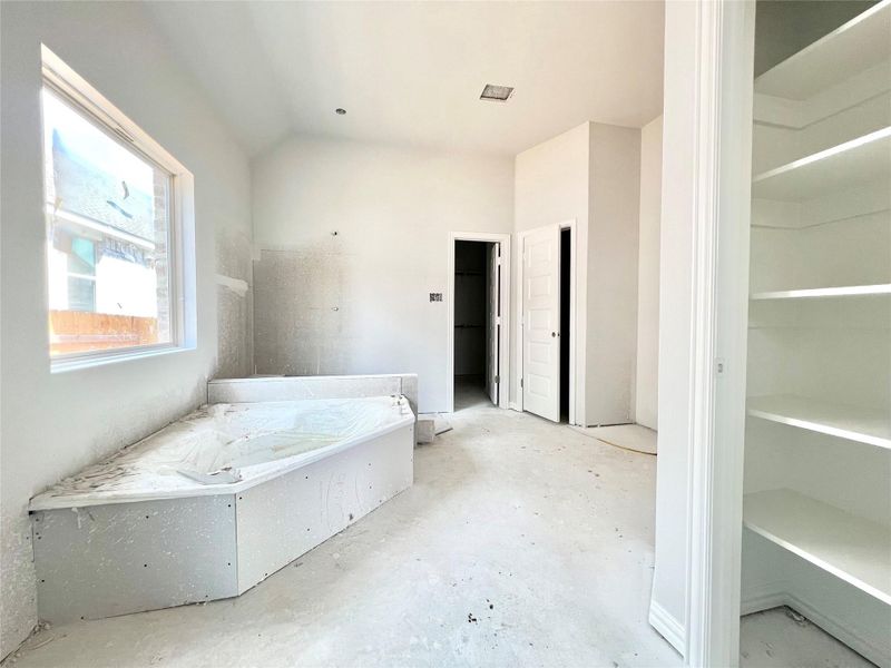 Bathroom featuring unfinished concrete flooring and vaulted ceiling Bathroom featuring unfinished concrete flooring and vaulted ceiling
