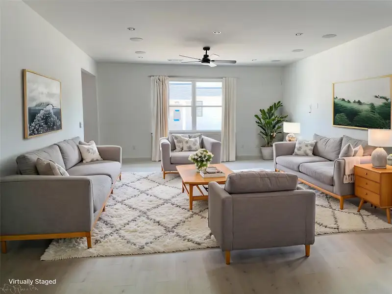 Living room with light wood-type flooring, a ceiling fan, and recessed lighting Living room with light wood-type flooring, a ceiling fan, and recessed lighting