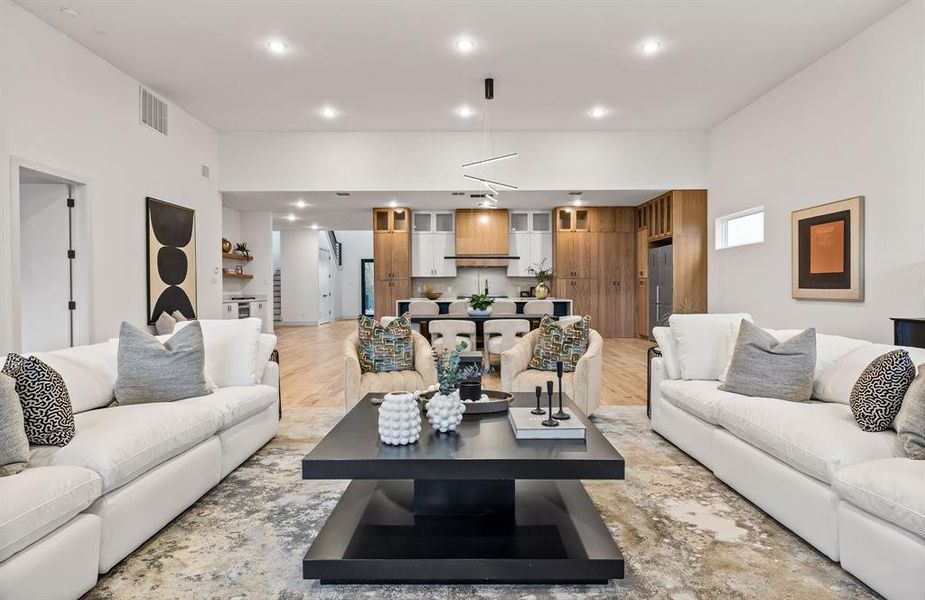 Living room featuring light hardwood / wood-style flooring and a notable chandelier