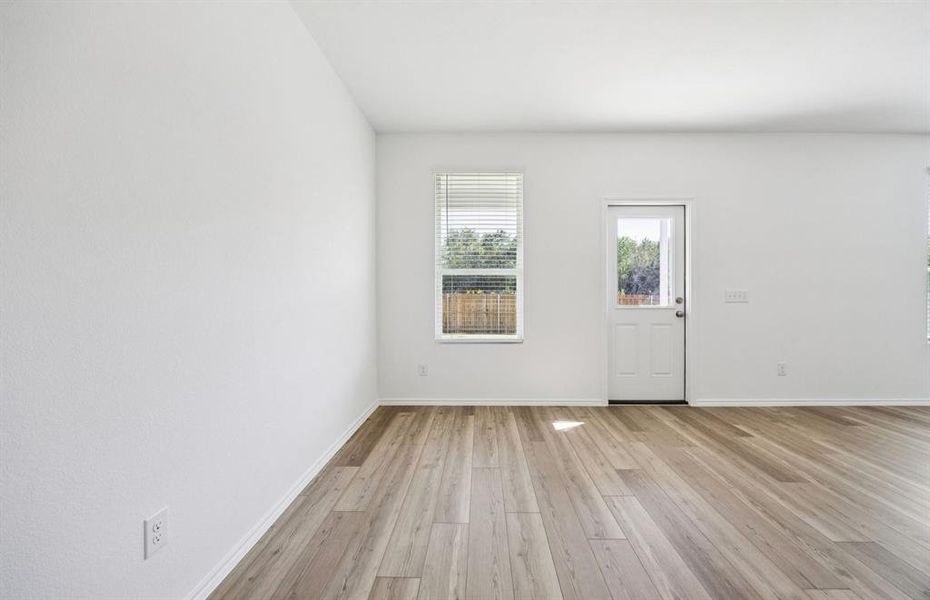 Dining nook off kitchen with large windows