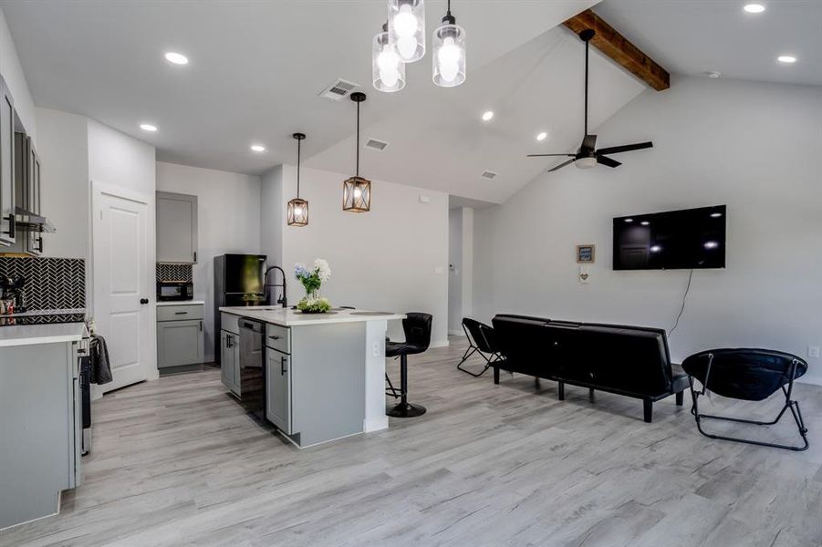 Kitchen with gray cabinetry, backsplash, recessed lighting, light wood-type flooring, and beamed ceiling Kitchen with gray cabinetry, backsplash, recessed lighting, light wood-type flooring, and beamed ceiling