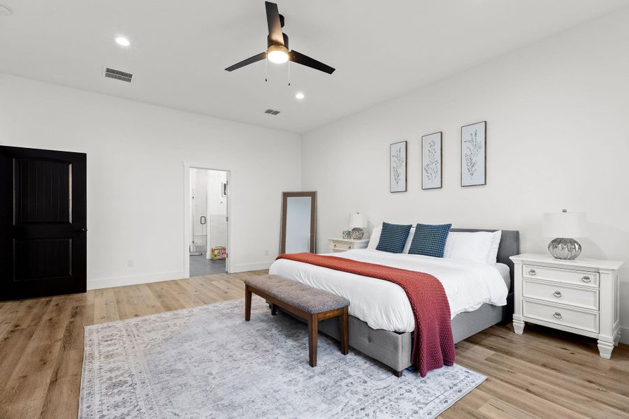 Bedroom with light wood-style floors, a ceiling fan, and recessed lighting