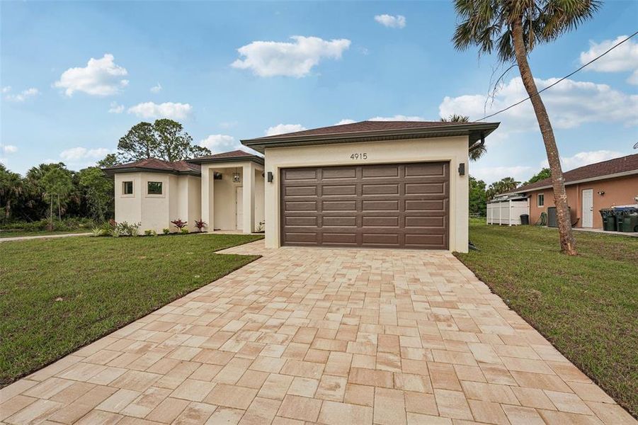 Front exterior of a new home in , North Port, FL, highlighting curb appeal (Image 2). Front exterior of a new home in , North Port, FL, highlighting curb appeal (Image 2).