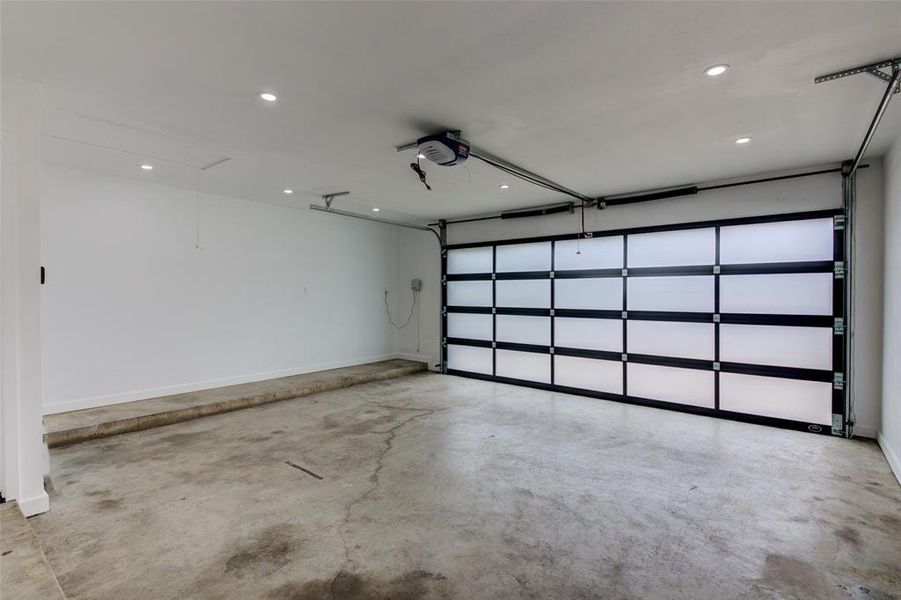 Full glass garage door brings in natural privacy light, with recessed cans for additional workshop lighting!