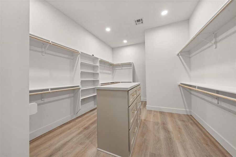 Spacious closet featuring light wood finished floors Spacious closet featuring light wood finished floors