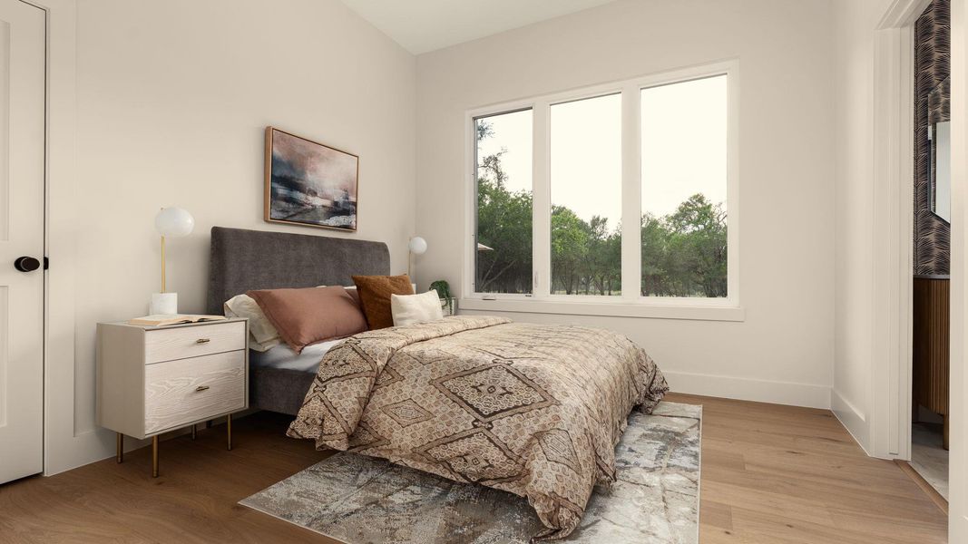 Hardwood floors and a tranquil outdoor vista frame this peaceful bedroom retreat. Hardwood floors and a tranquil outdoor vista frame this peaceful bedroom retreat.