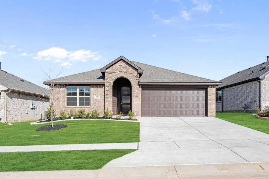 Single-story brick home with arched entry, two-car garage, and manicured front lawn Single-story brick home with arched entry, two-car garage, and manicured front lawn