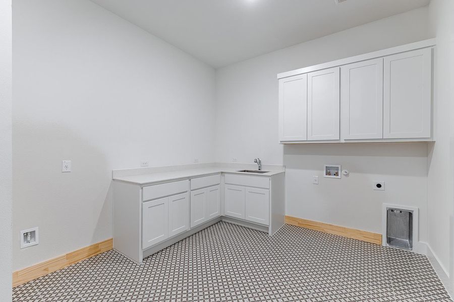 Laundry room with hookup for a washing machine, electric dryer hookup, and cabinet space