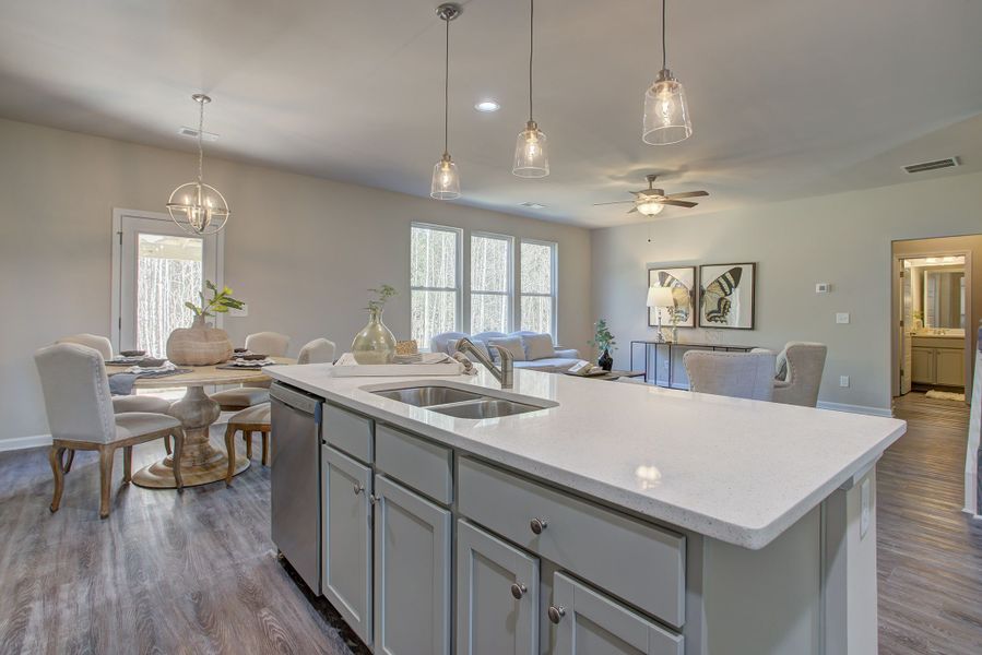 The kitchen overlooks the sunlit breakfast room and the spacious living room