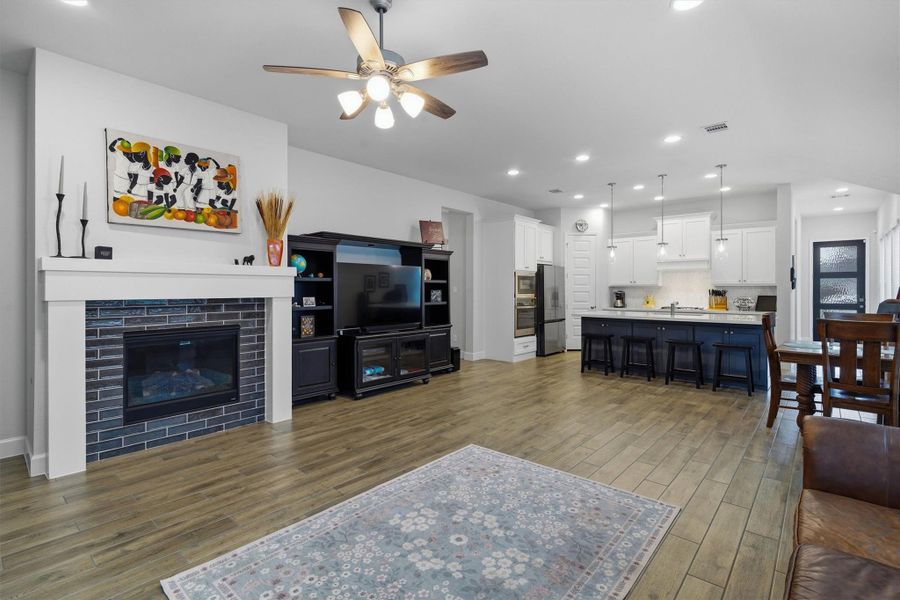 Spacious living room with cozy fireplace, opens up in to the kitchen Spacious living room with cozy fireplace, opens up in to the kitchen