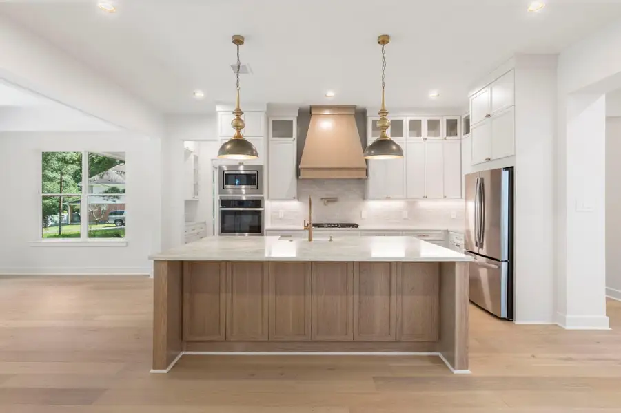 Enjoy casual meals or holiday baking at the huge kitchen island with custom lighting. Enjoy casual meals or holiday baking at the huge kitchen island with custom lighting.
