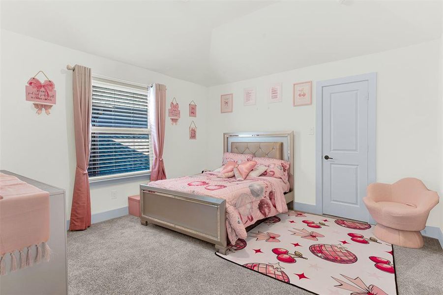 Bedroom featuring light carpet and lofted ceiling Bedroom featuring light carpet and lofted ceiling