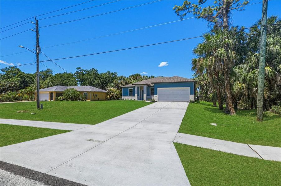 Front exterior of a new home in , North Port, FL, highlighting curb appeal (Image 15). Front exterior of a new home in , North Port, FL, highlighting curb appeal (Image 15).