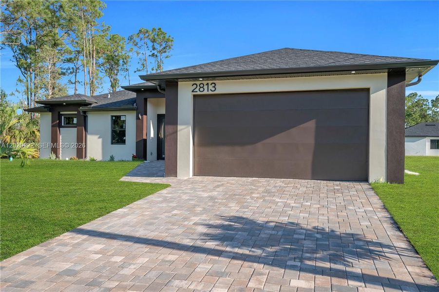 Front exterior of a new home in , Lehigh Acres, FL, highlighting curb appeal (Image 23).