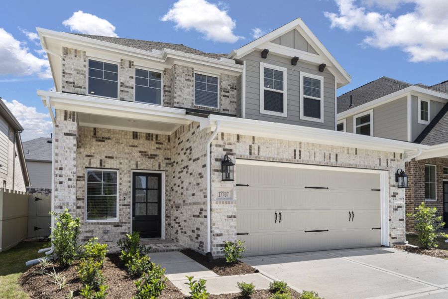 Front exterior of a new home in The Woodlands Hills, Willis, TX, highlighting curb appeal (Image 21).