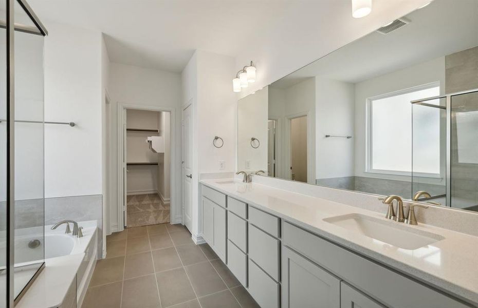 Owner's bath with dual vanity and oversized shower *real home pictured