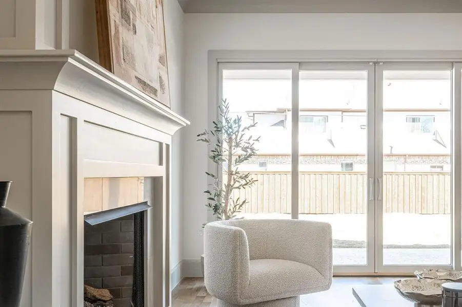 Sitting room with light wood finished floors and a fireplace