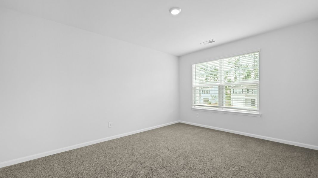 Spacious, unfurnished interior of a new home in Pine Hills Townhomes at Cane Bay, Summerville (Image 26).