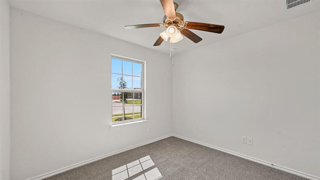 White-painted interior room featuring gray carpet flooring and a window with white trim