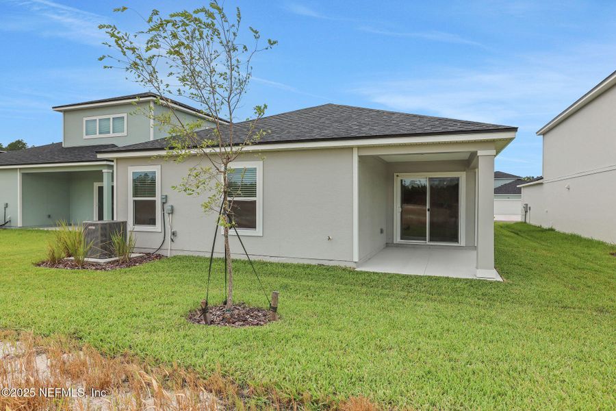 Front exterior of a new home in Bellbrooke, Jacksonville, FL, highlighting curb appeal (Image 10).
