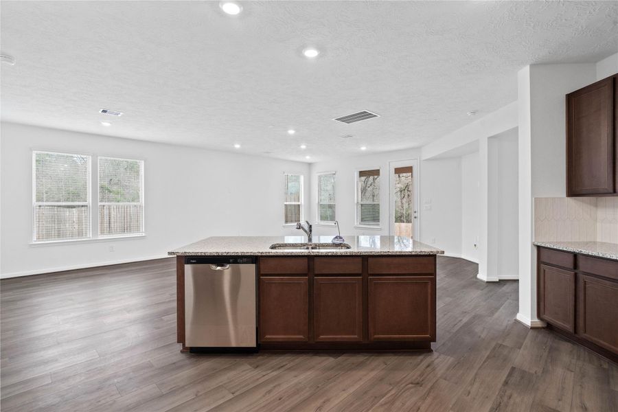 A commanding view of the open-concept design which seamlessly connects the living, dining, and kitchen areas—perfect for both everyday living and entertaining! A commanding view of the open-concept design which seamlessly connects the living, dining, and kitchen areas—perfect for both everyday living and entertaining!