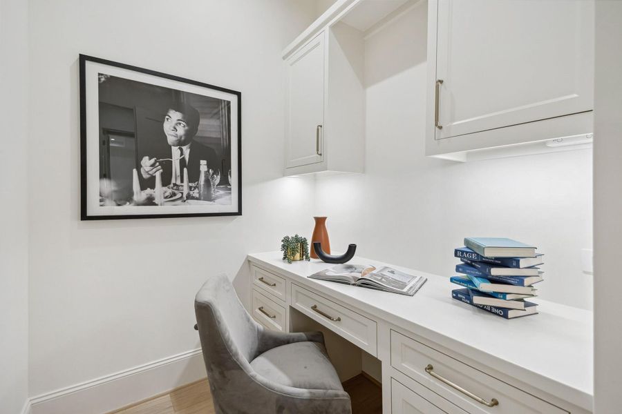 [Office Nook] Secluded office nook just adjacent to primary bedroom featuring built-in desk space and storage.