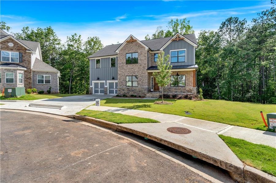 Front exterior of a new home in Palmer Falls, Douglasville, GA, highlighting curb appeal (Image 20).