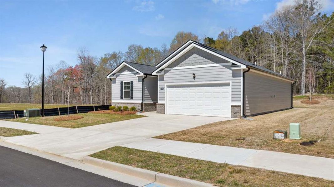 Front exterior of a new home in Champion's Run, Lithonia, GA, highlighting curb appeal (Image 2).