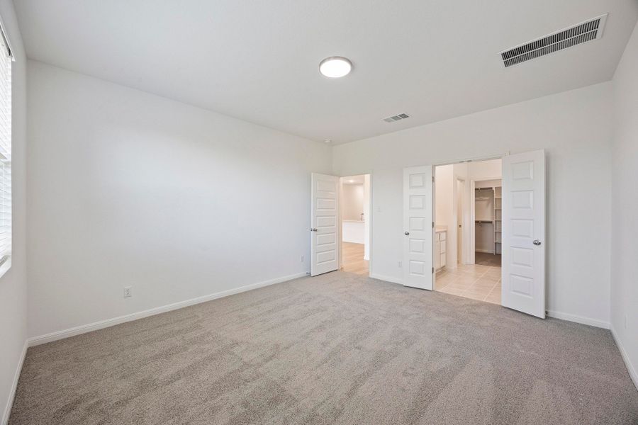 Primary Suite in the Magnolia home plan by Trophy Signature Homes – REPRESENTATIVE PHOTO