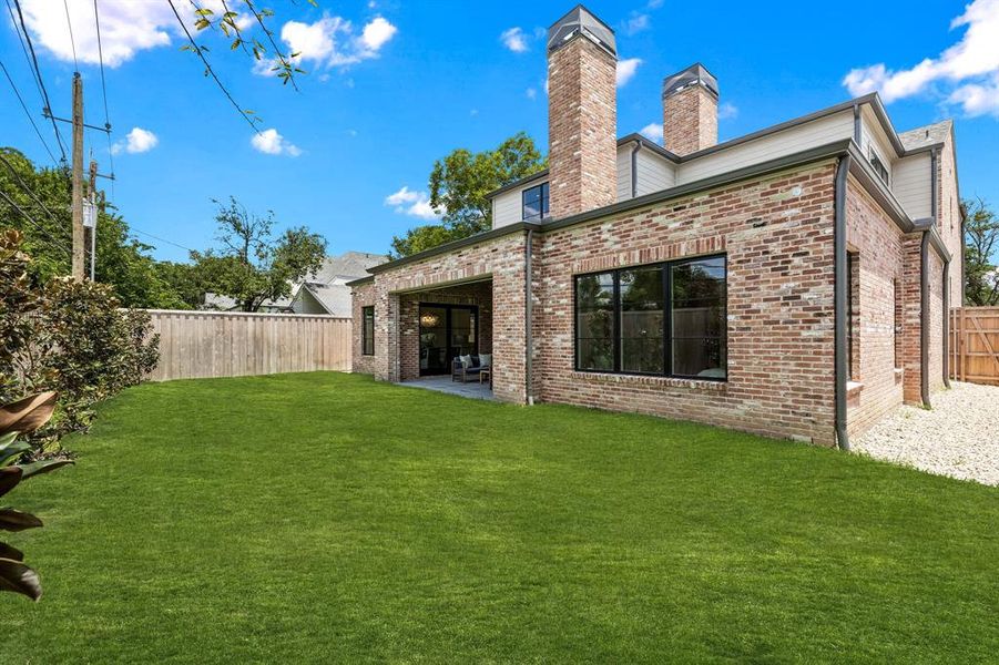 Back of house with a patio area and a yard