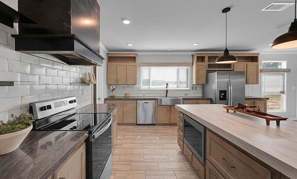 Kitchen featuring stainless steel appliances, decorative backsplash, wall chimney range hood, open shelves, and recessed lighting Kitchen featuring stainless steel appliances, decorative backsplash, wall chimney range hood, open shelves, and recessed lighting