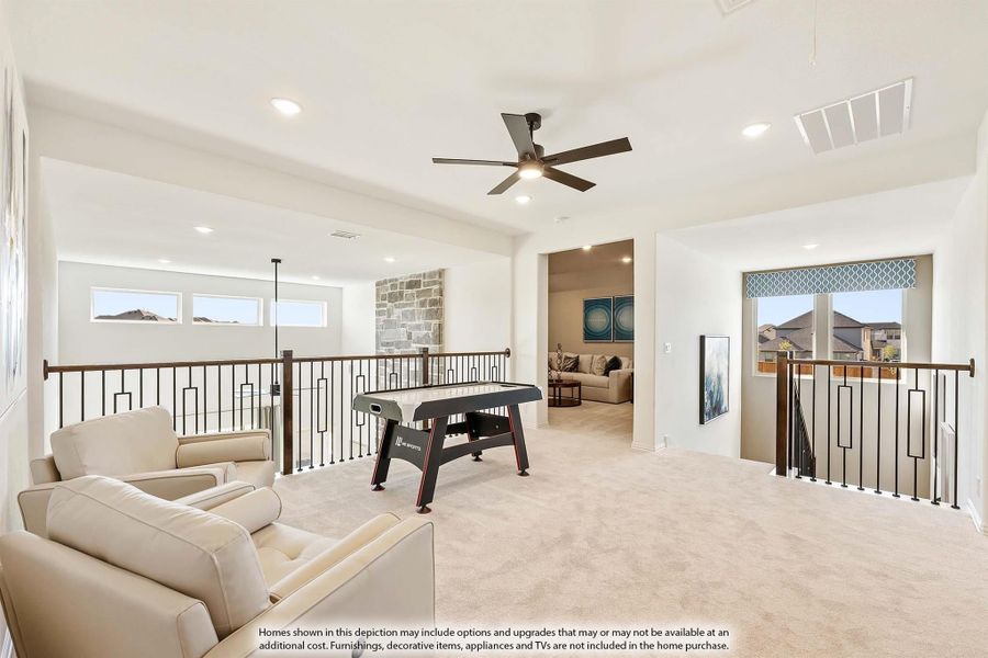 Upstairs game room with air hockey table, seating area, carpet, and open railing overlooking lower level Upstairs game room with air hockey table, seating area, carpet, and open railing overlooking lower level