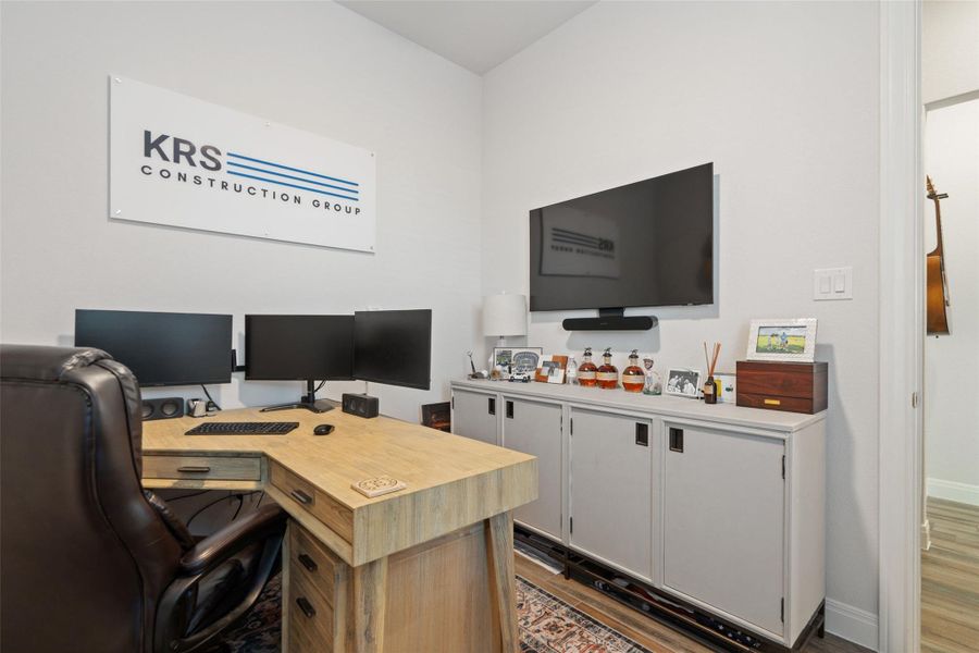 A dedicated home office provides a functional workspace with ample cabinetry and wall-mounted display. A dedicated home office provides a functional workspace with ample cabinetry and wall-mounted display.