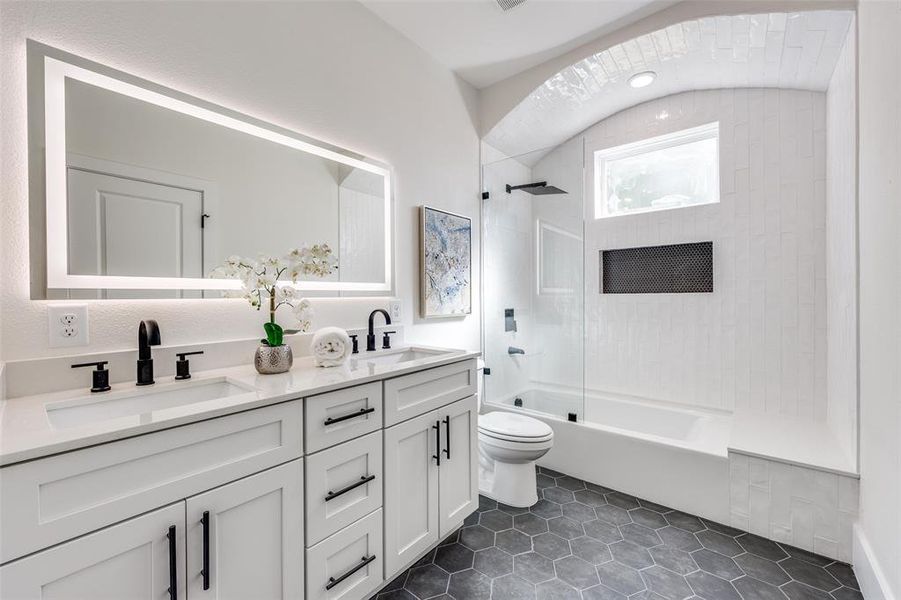 Full bathroom with double vanity, shower / tub combination, and tile patterned flooring Full bathroom with double vanity, shower / tub combination, and tile patterned flooring