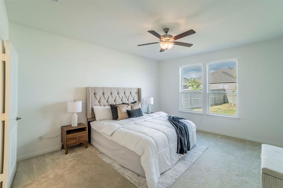 Bedroom featuring carpet floors and a ceiling fan Bedroom featuring carpet floors and a ceiling fan