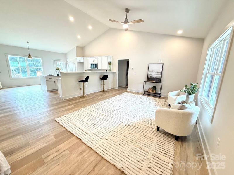 Open floor plan with vaulted ceilings in main areas