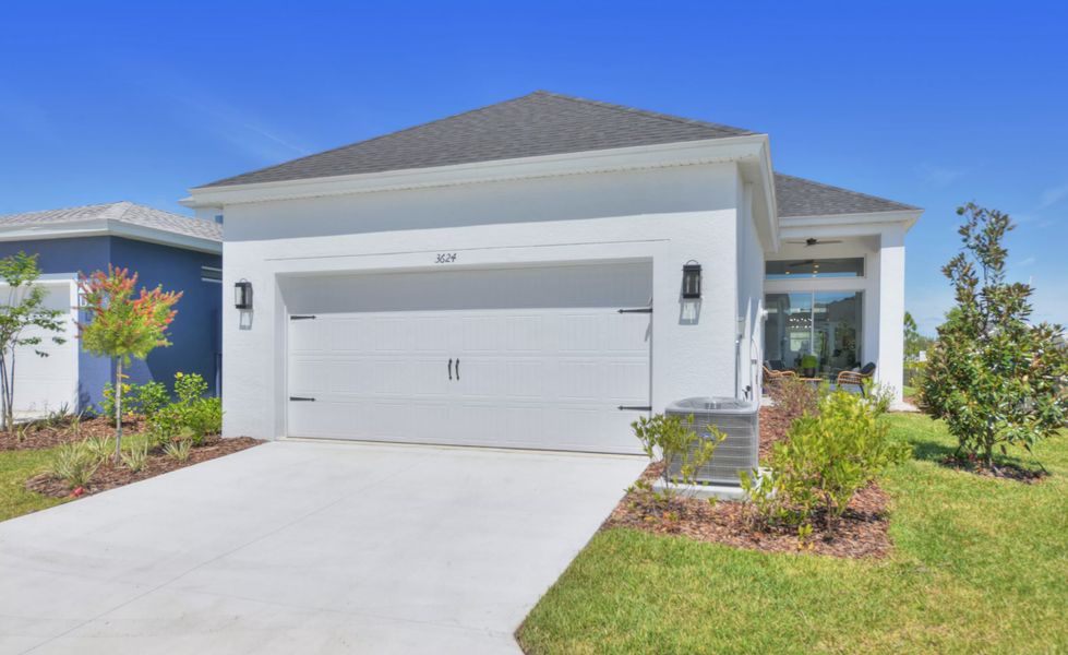 Front exterior of a new home in Persimmon Park, Wesley Chapel, FL, highlighting curb appeal (Image 20). Front exterior of a new home in Persimmon Park, Wesley Chapel, FL, highlighting curb appeal (Image 20).