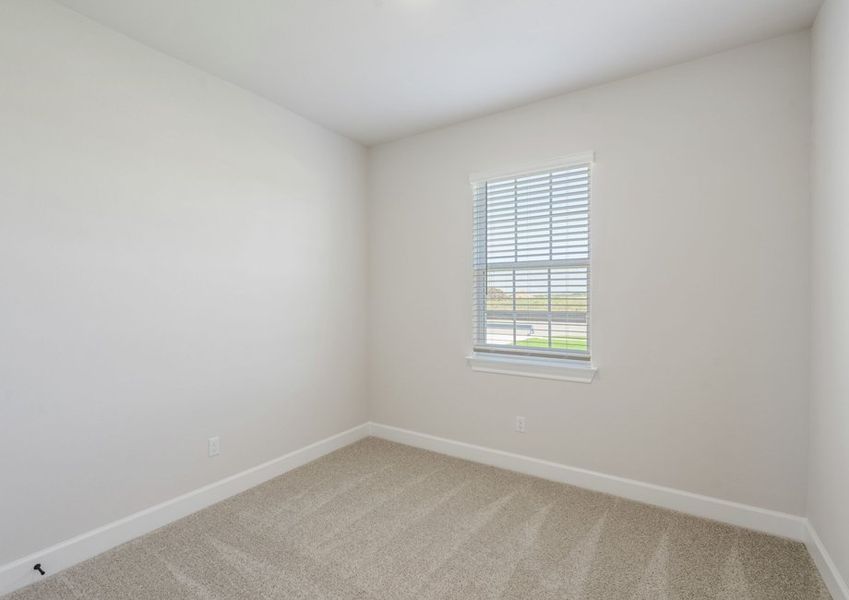 Secondary bedroom with lush carpet flooring