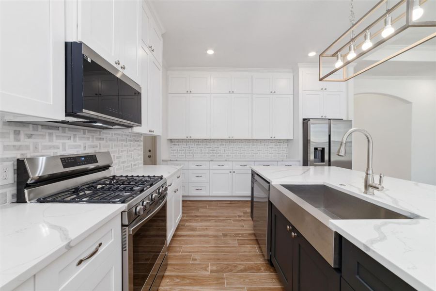 Functional layout for easy cooking and clean up including a stainless farmhouse sink. Functional layout for easy cooking and clean up including a stainless farmhouse sink.