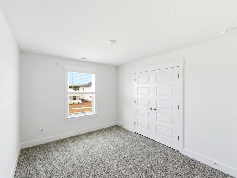 Spacious, unfurnished interior of a new home in The Coves at Lakes of Cane Bay II, Summerville (Image 30).